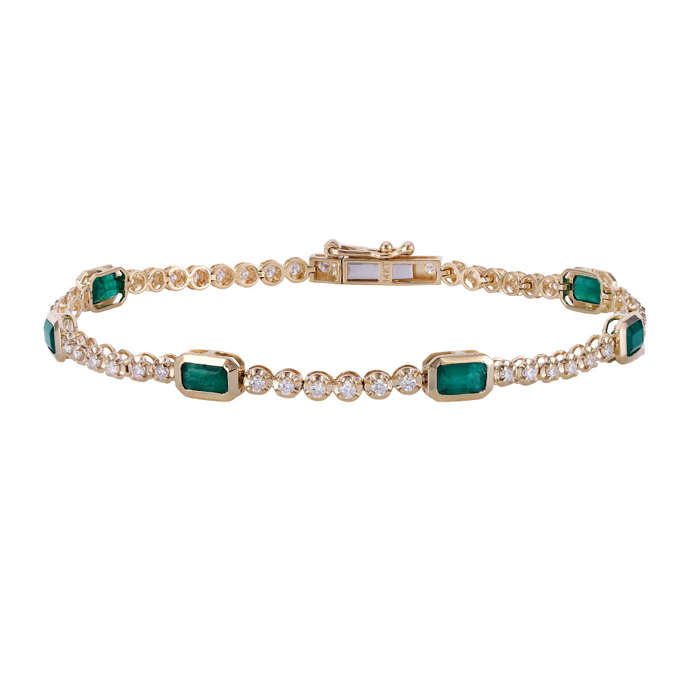 A yellow gold tennis bracelet featuring rectangular emerald-cut green stones and rows of round clear stones, displayed on a clean white background.