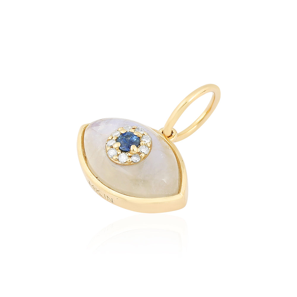 A gold pendant featuring a teardrop-shaped white moonstone with a central blue sapphire surrounded by small clear stones, set in a gold frame with a hanging loop.