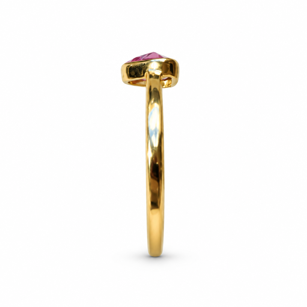 Gold ring with triangular pink stone, side profile on white background