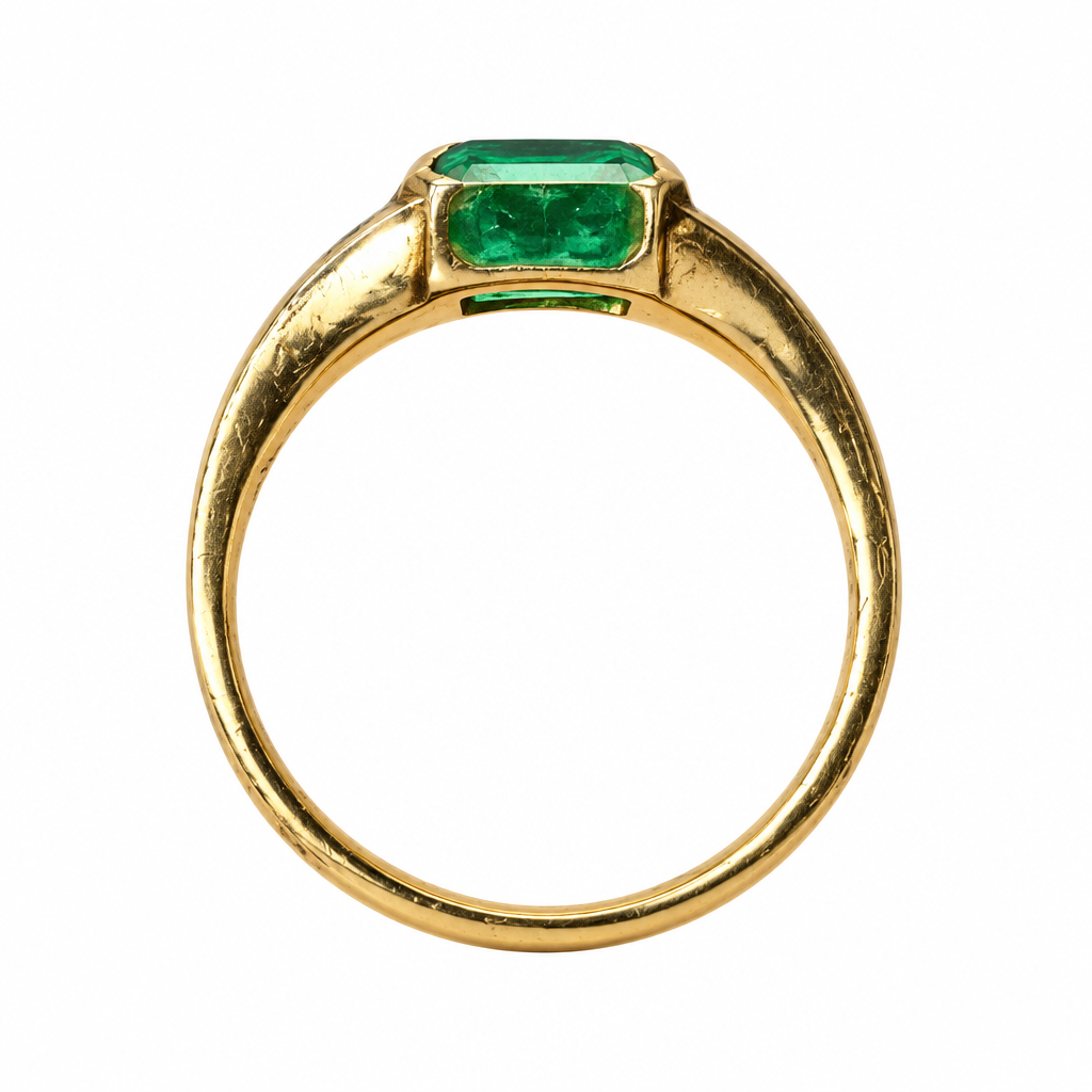 Band profile of emerald bezel ring on white background