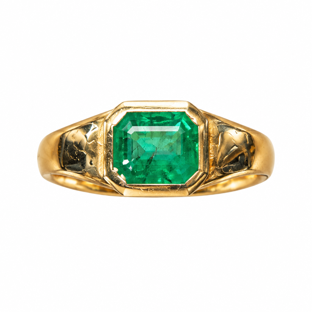 Face view of emerald bezel ring on white background