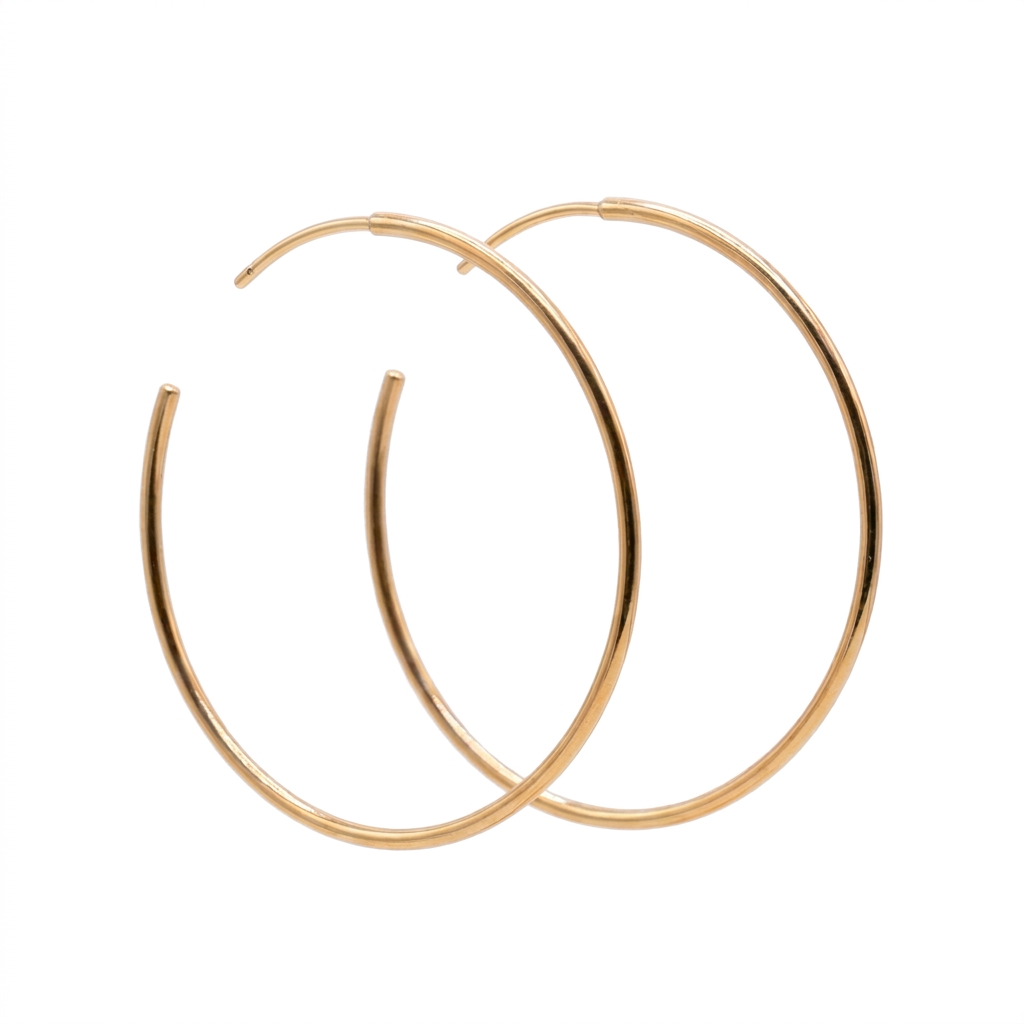Pair of thin gold Everyday Hoops with curved posts, overlapping on a white background.