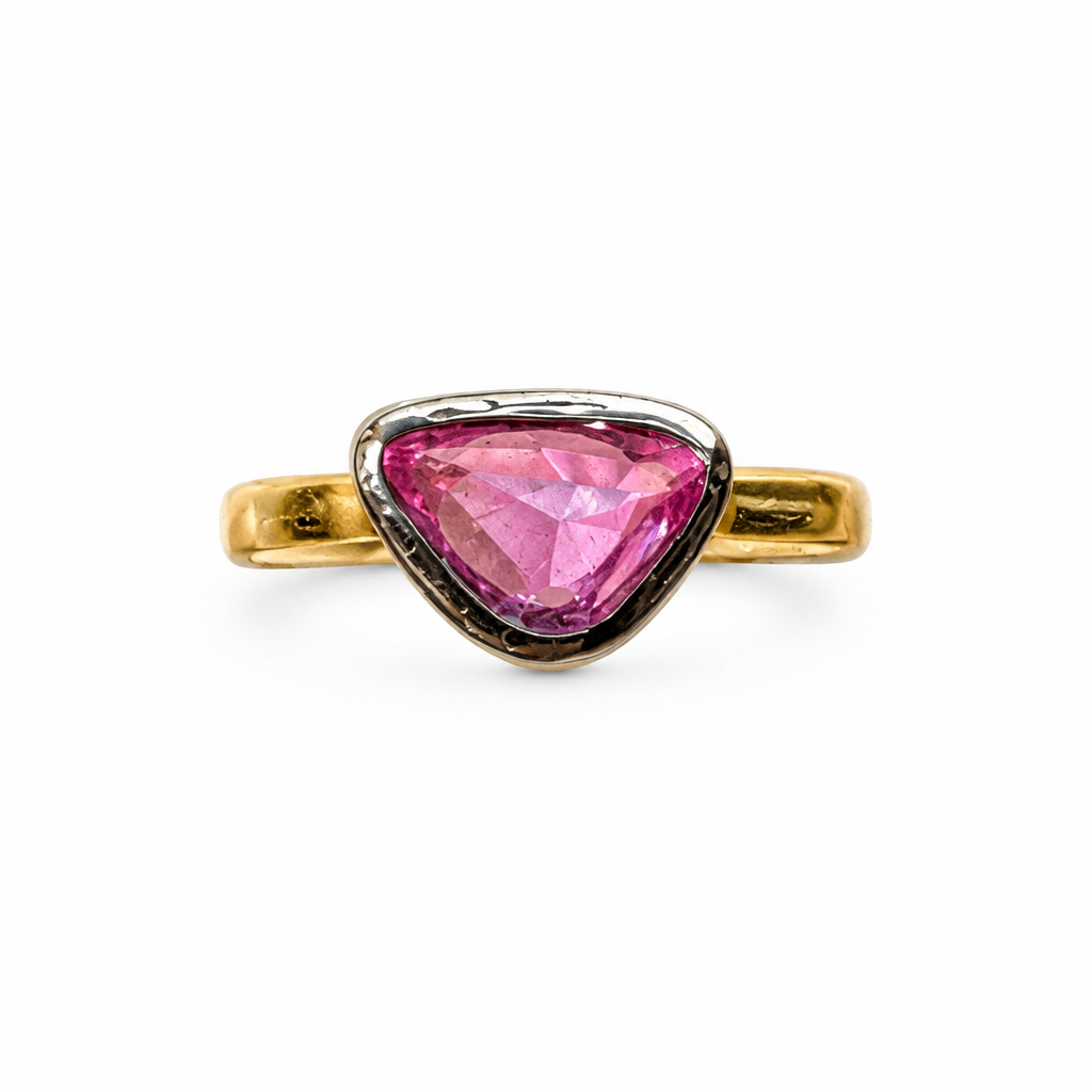 Gold ring with triangular pink stone, front view on white background