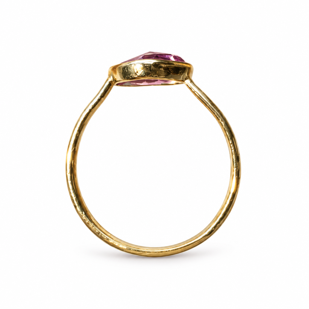 Gold ring with triangular pink stone, full profile on white background