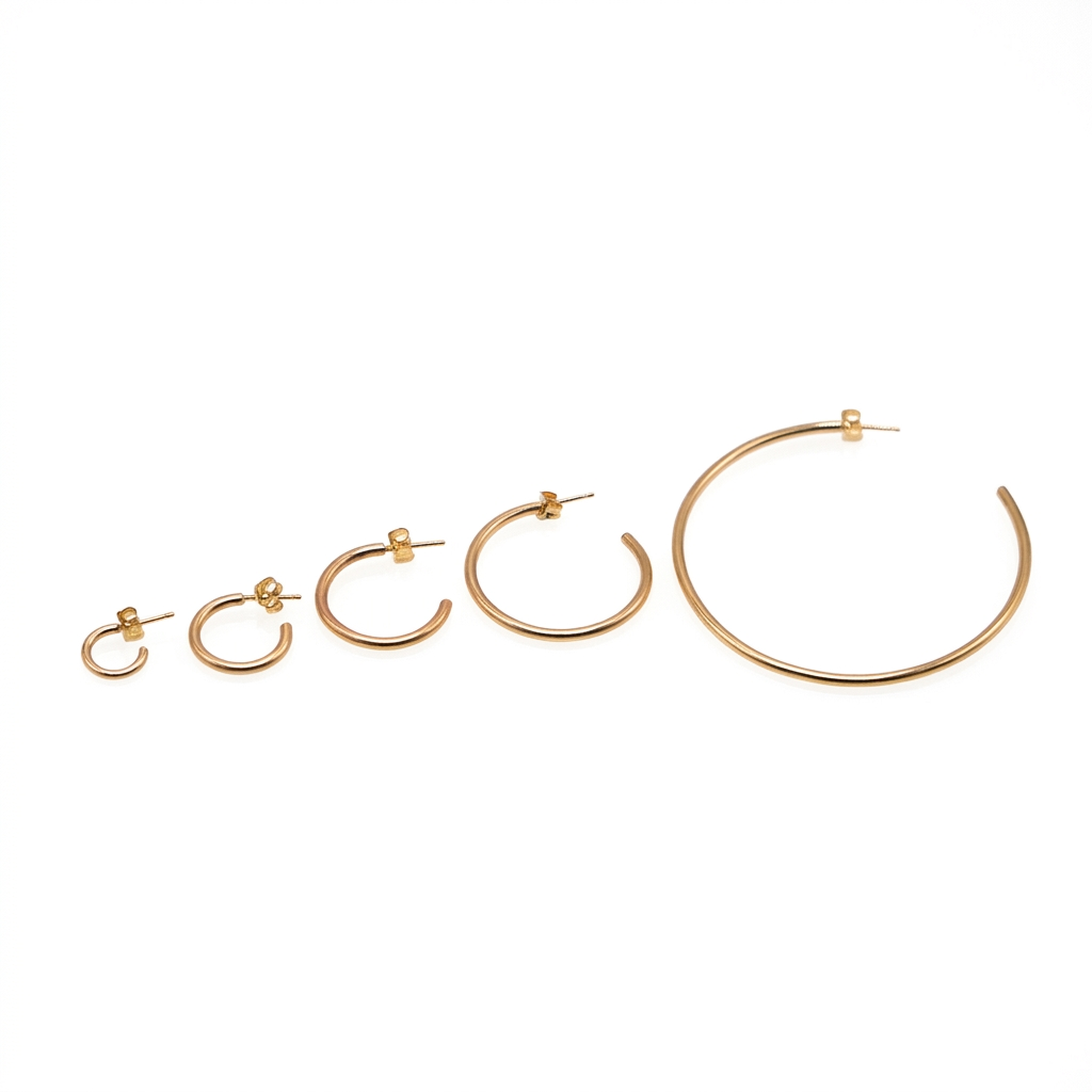 Five gold Everyday Hoop earrings arranged from smallest to largest, with posts and backs visible on a white background.