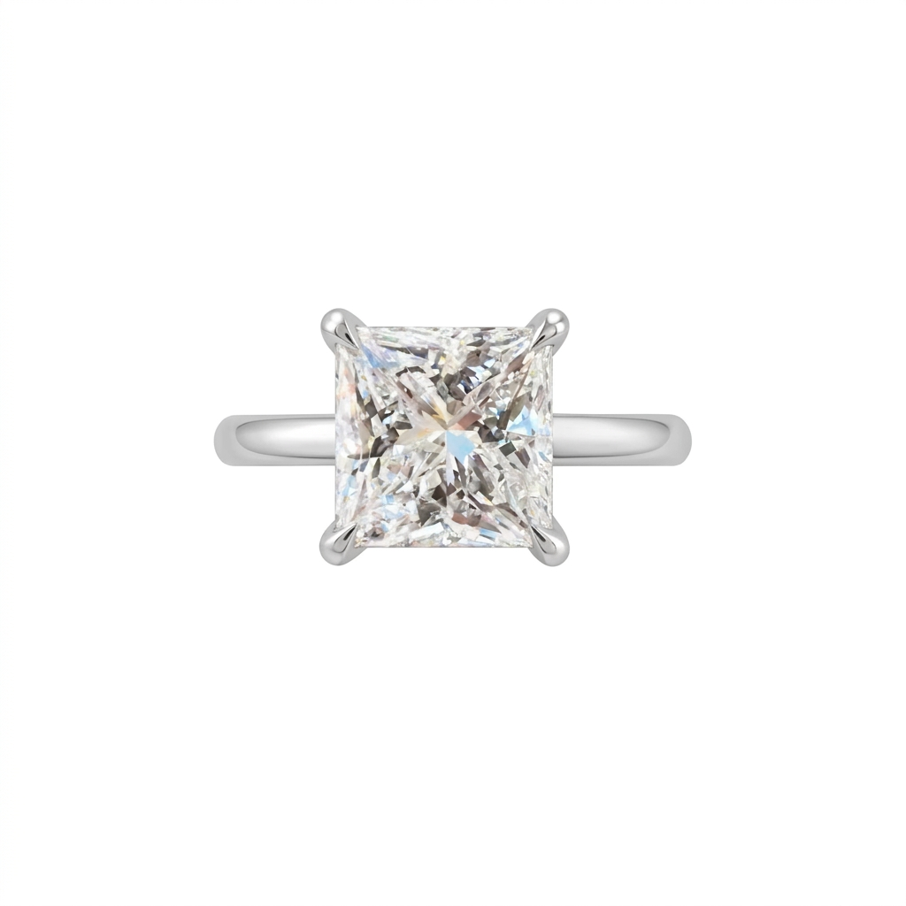 Front view of a princess-cut diamond engagement ring with four corner prongs and a polished white-metal band on a white background.