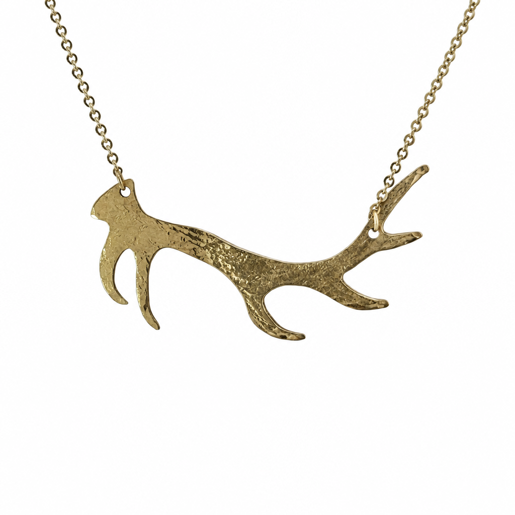 Gold-tone antler pendant necklace on a white background