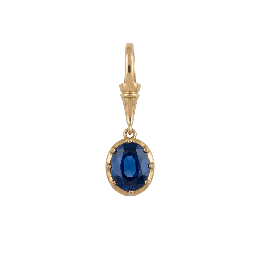 Georgian Sapphire Pendant with an oval blue sapphire in a yellow gold prong setting and elongated bail, shown on a white background.